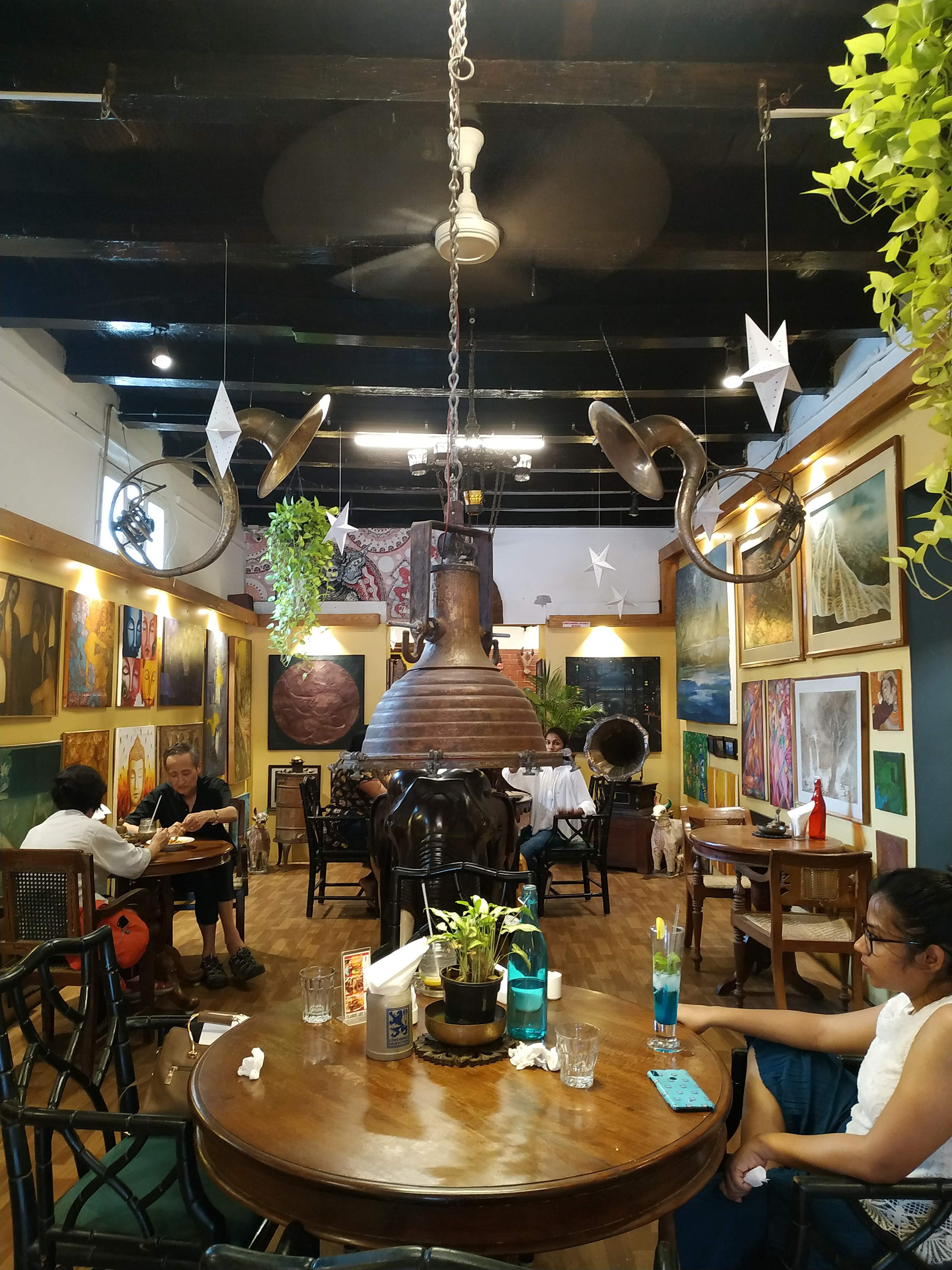 Restaurant,Room,Interior design,Building,Coffeehouse,Table,Furniture,Ceiling,Café,Home