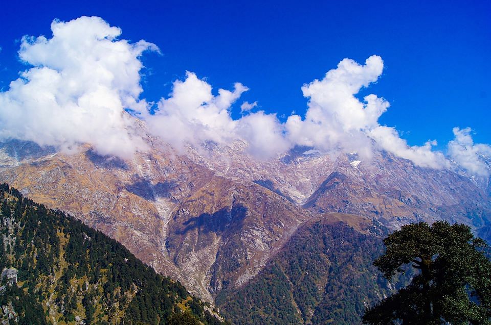 Mountainous landforms,Mountain,Sky,Mountain range,Cloud,Ridge,Natural landscape,Alps,Cumulus,Highland