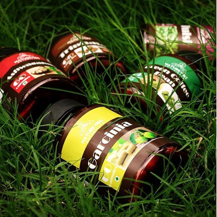 Green,Beverage can,Grass,Tire,Alcohol,Beer bottle,Plant,Drink,Beer,Bottle