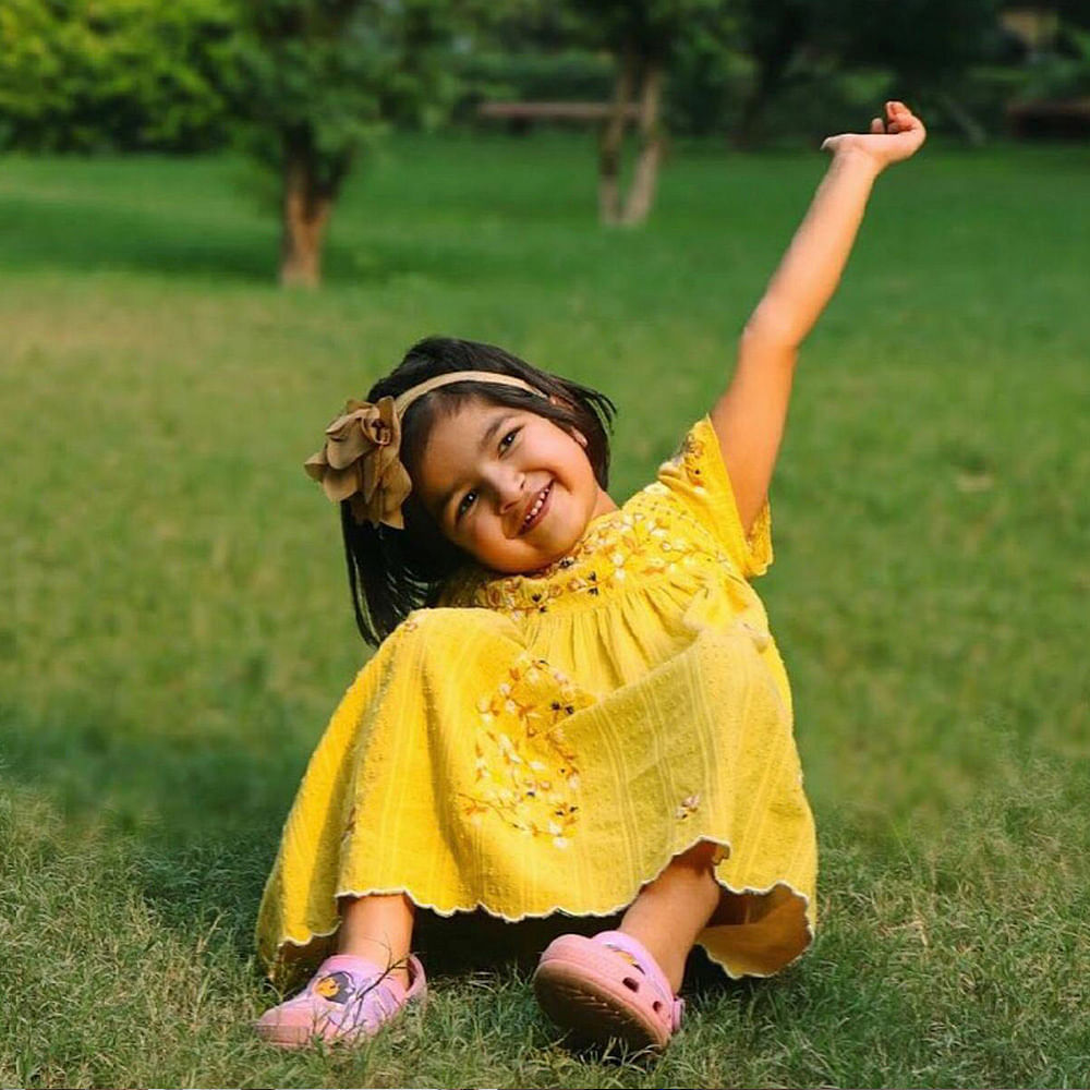 People in nature,Facial expression,Yellow,Grass,Happy,Smile,Fun,Arm,Lawn,Meadow