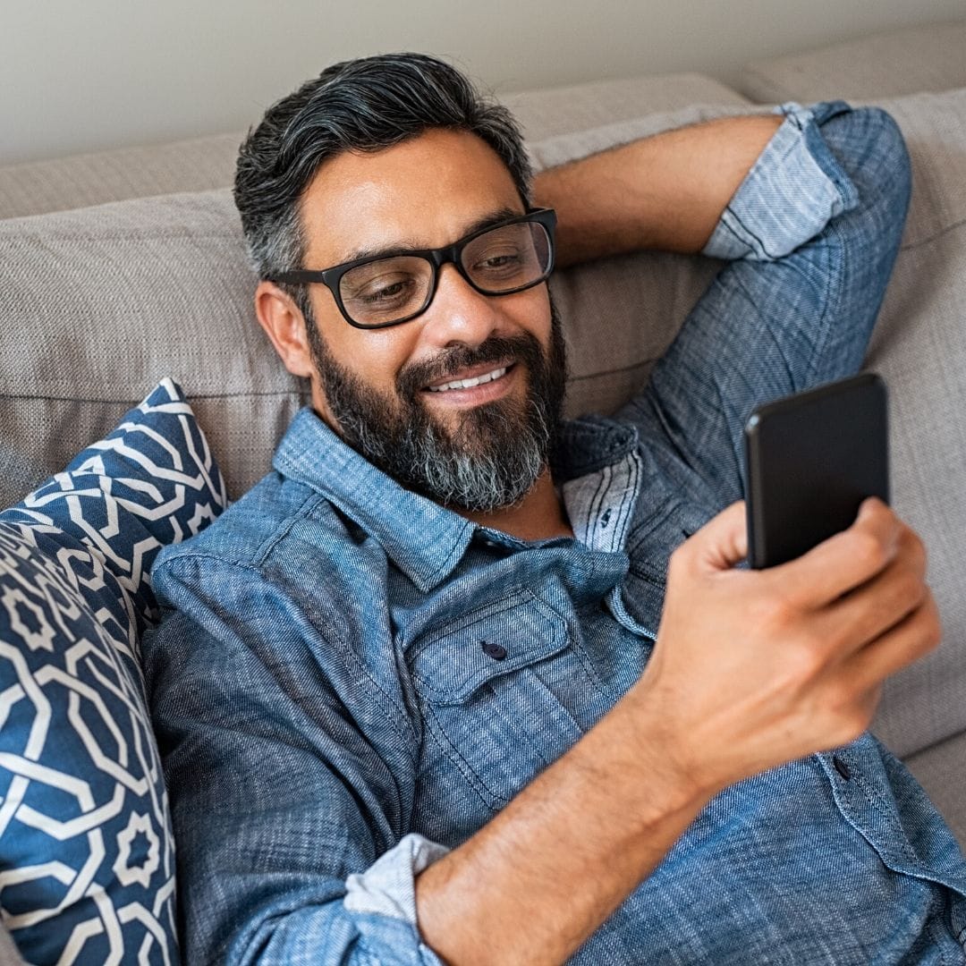 Facial hair,Hair,Beard,Glasses,Gadget,Selfie,Electronic device,Technology,Mobile phone,Sitting