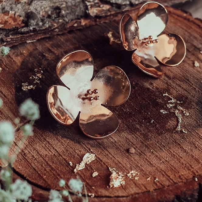 Wood,Leaf,Still life photography,Fashion accessory,Metal,Jewellery,Earrings,Plant,Still life,Circle