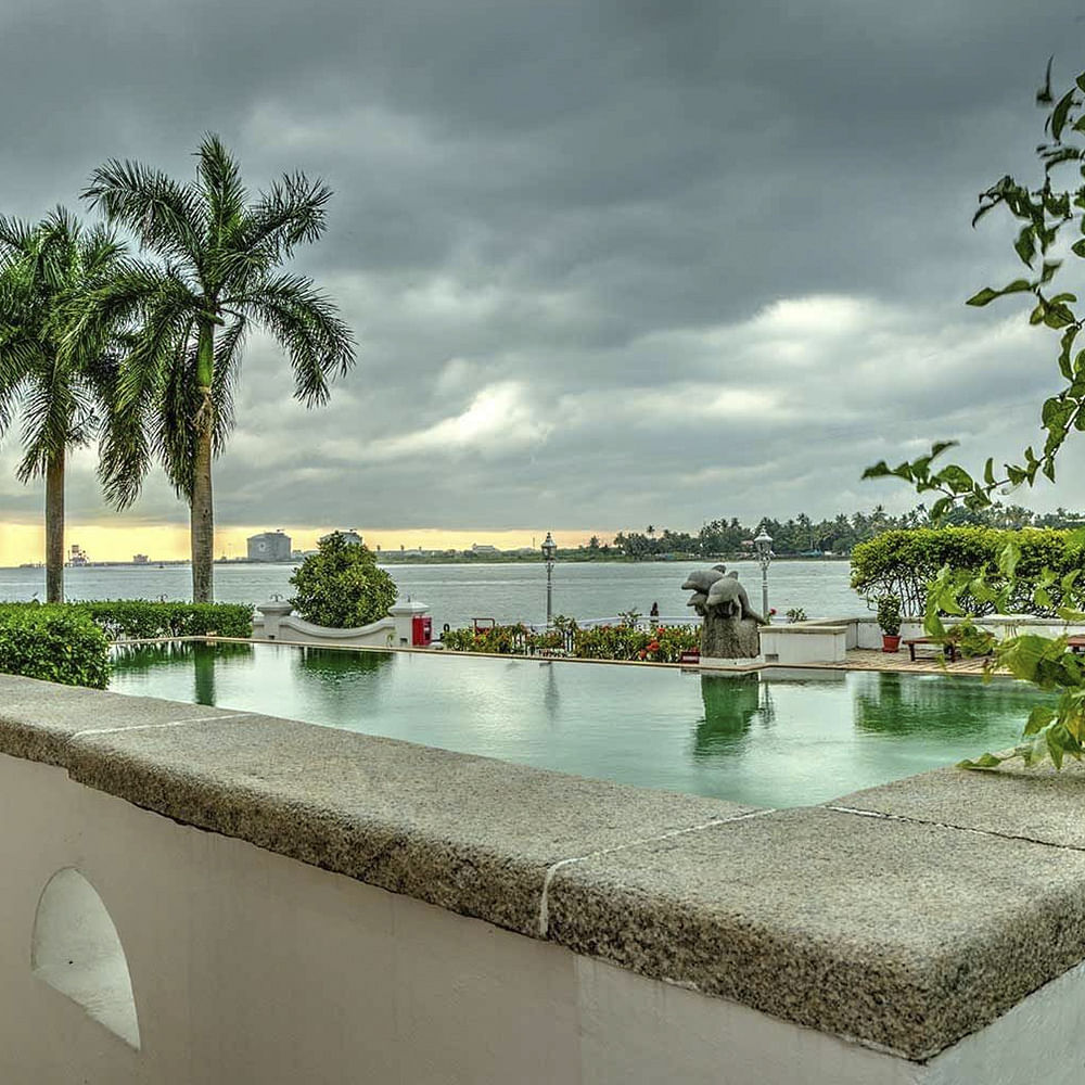 Sky,Water,Water resources,Tree,Natural landscape,Palm tree,Architecture,Landscape,Reflecting pool,Arecales