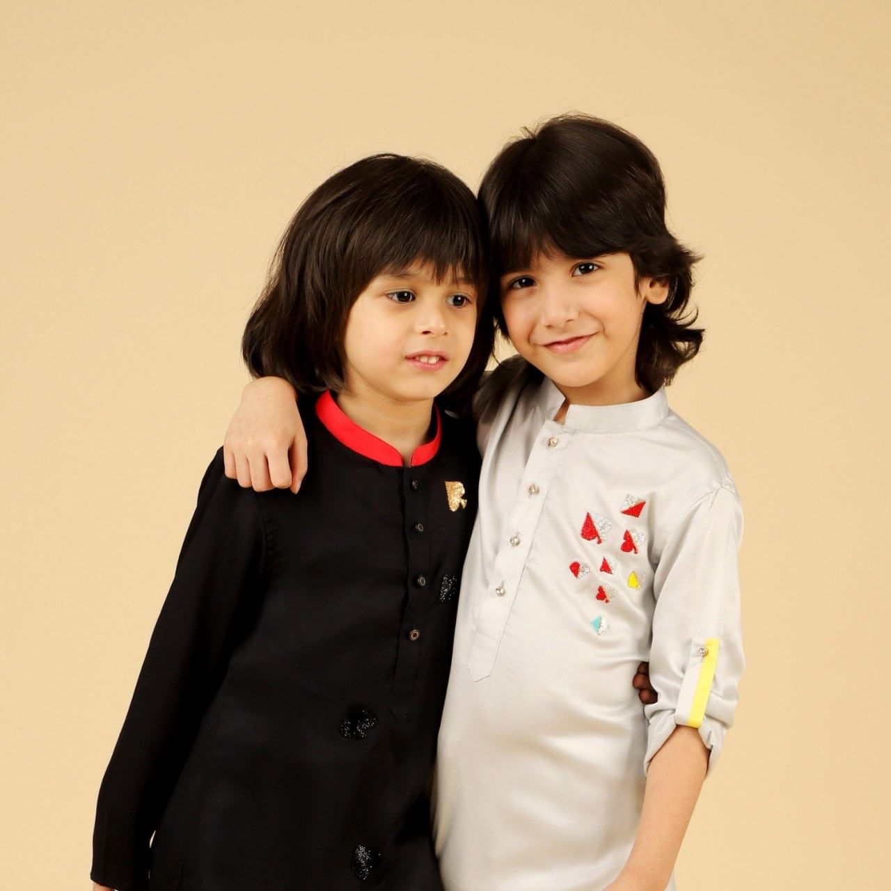 Child,Skin,Hairstyle,Outerwear,Sleeve,Smile,Black hair,Photography,Gesture