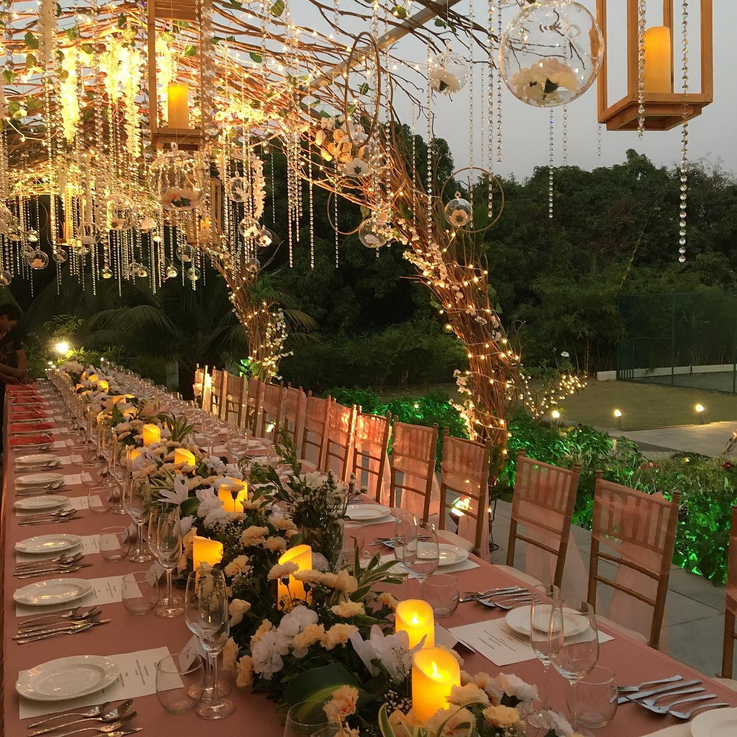 Lighting,Yellow,Landscape lighting,Tree,Plant,Building,Floral design,Floristry,Aisle,Ceremony