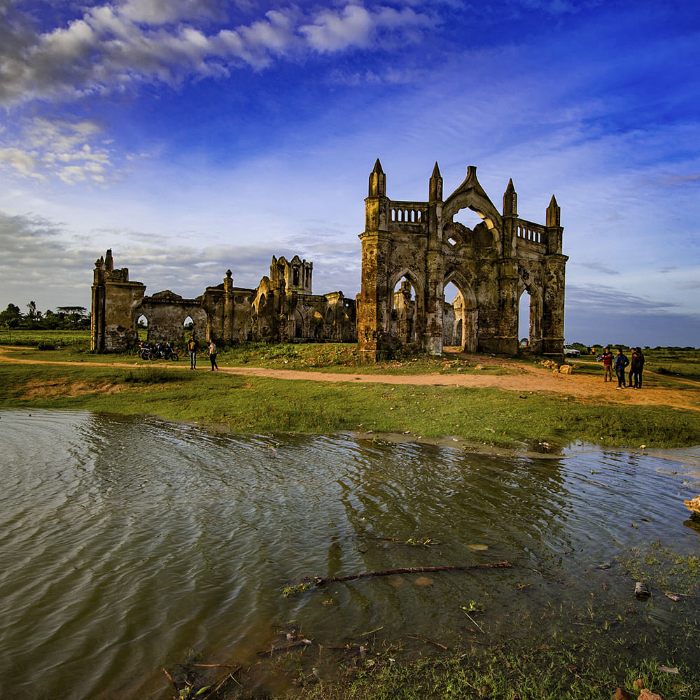 Sky,Reflection,Natural landscape,Architecture,Cloud,Building,River,Church,Ruins,Grass