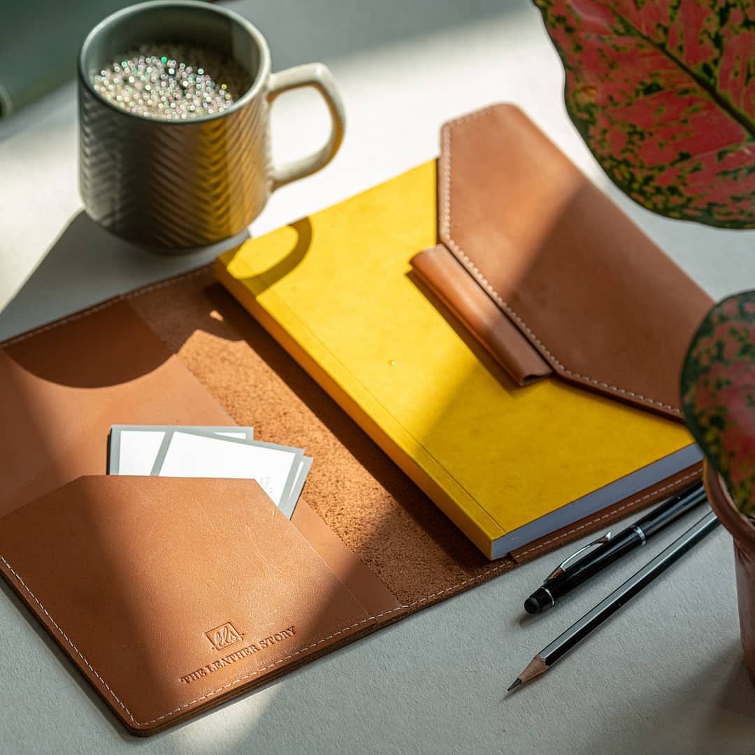 Leather,Cup,Brown,Coffee cup,Wallet,Table,Textile,Notebook,Placemat,Drinkware