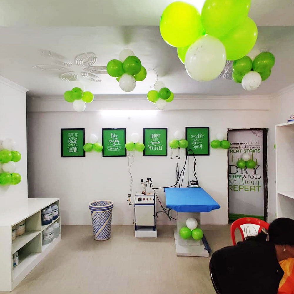 Green,Room,Interior design,Balloon,Wall,Hat,Party supply,Floor,Ceiling,Turquoise