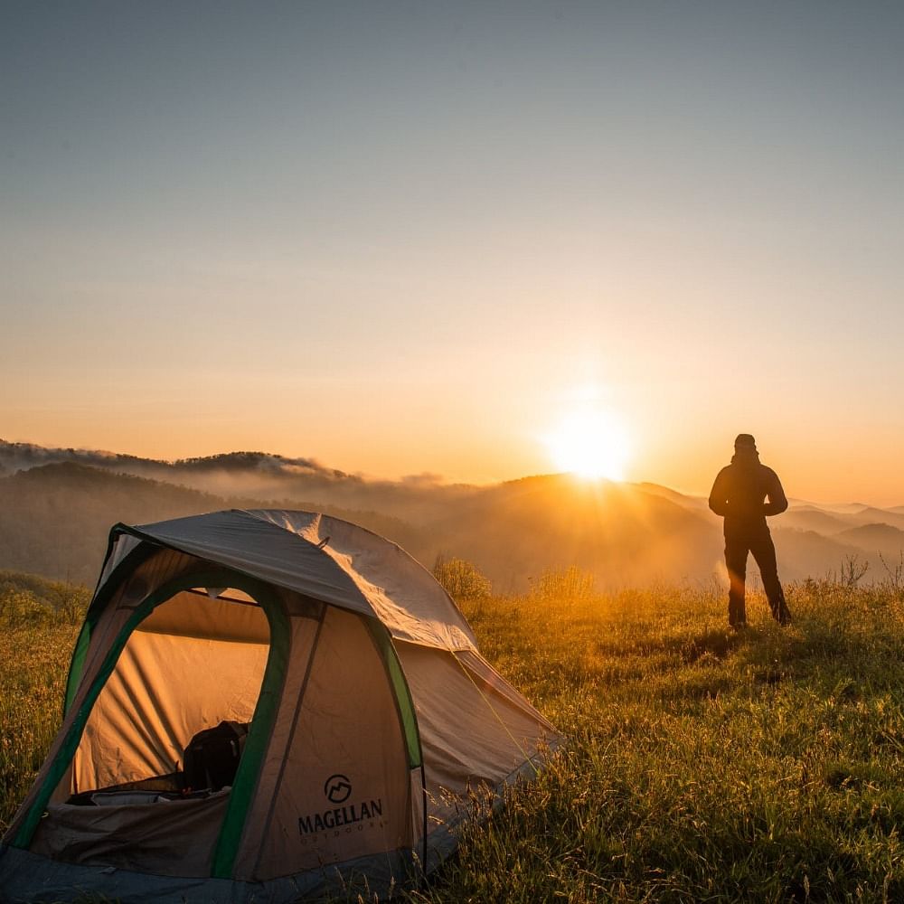 Tent,Natural environment,Camping,Landscape,Sun,Sunlight,People in nature,Plain,Sunrise,Outdoor recreation