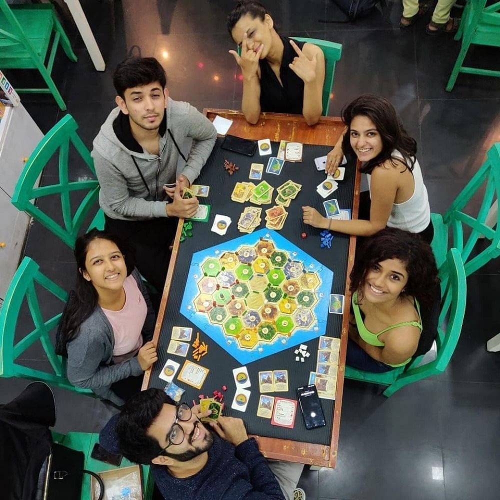 Face,Head,Fun,Indoor games and sports,Recreation,Leisure,Community,Tabletop game,Sharing,Friendship