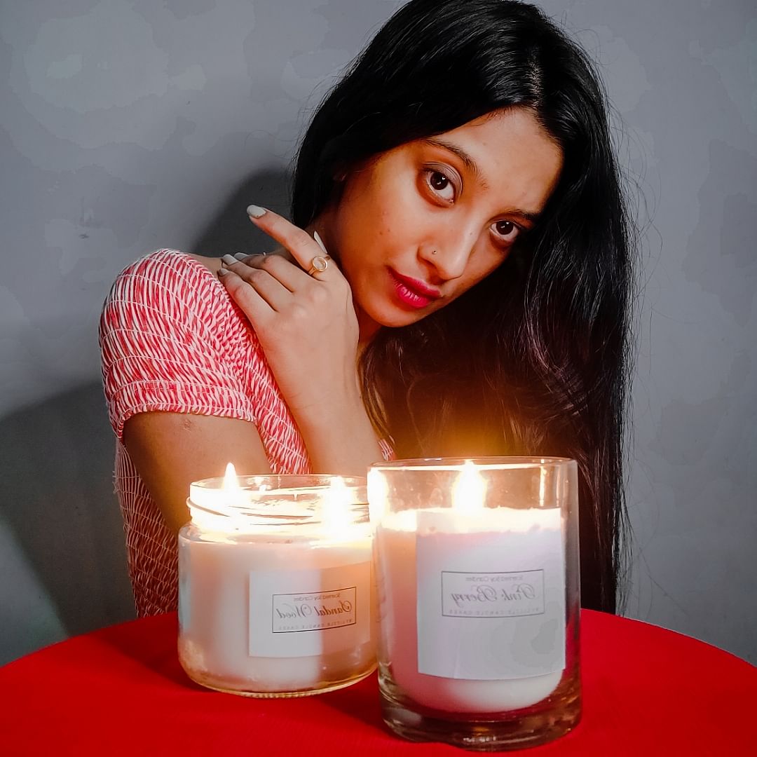 Candle,Lighting,Beauty,Lip,Skin,Material property,Wax,Black hair,Photo shoot,Interior design