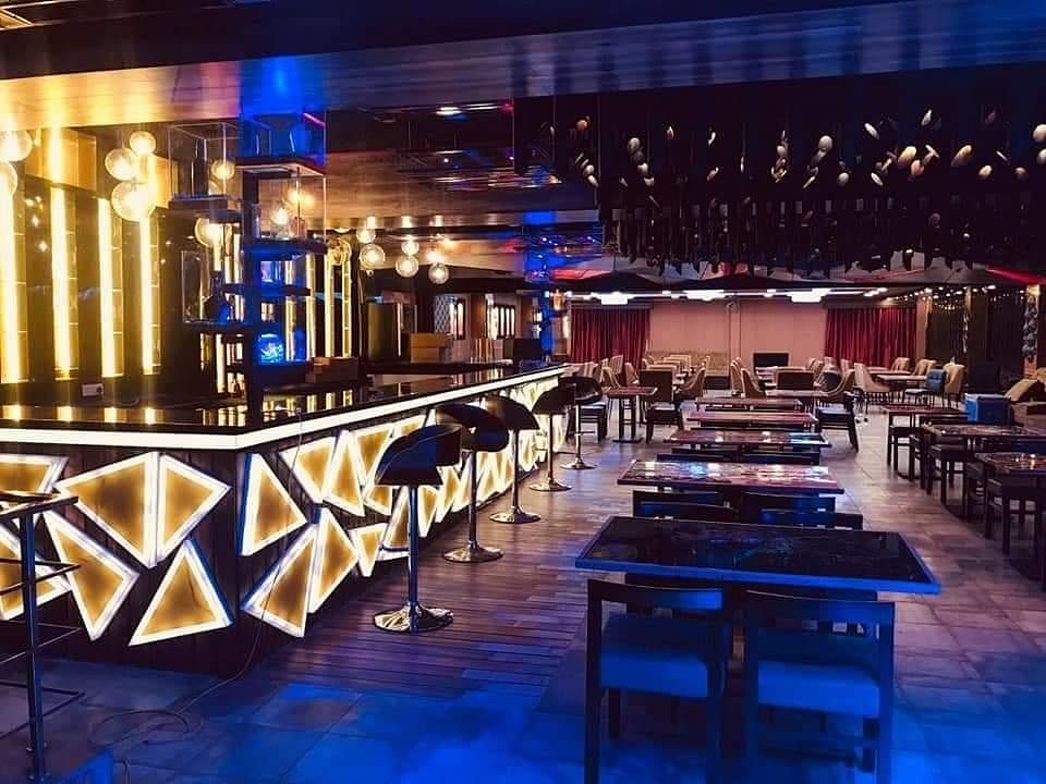 Building,Lighting,Interior design,Bar,Restaurant,Music venue,Architecture,Table,Nightclub,Room