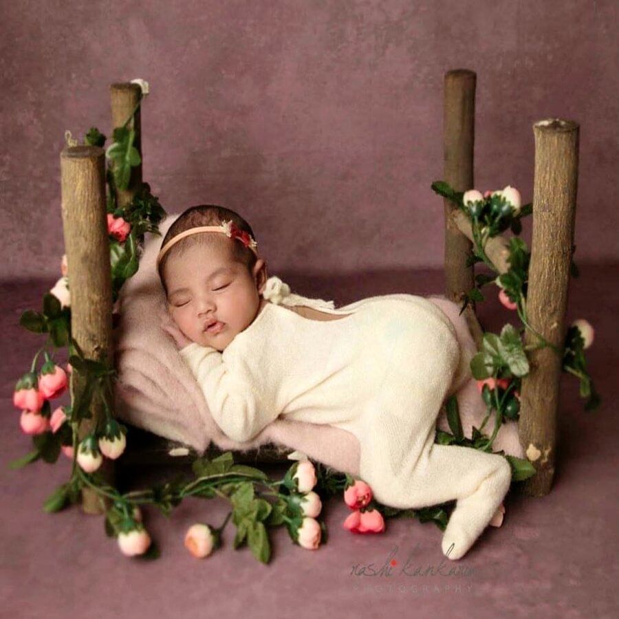 Petal,Mammal,Baby & toddler clothing,Hair accessory,Still life photography,Headpiece,Baby,Cut flowers,Floral design,Creative arts