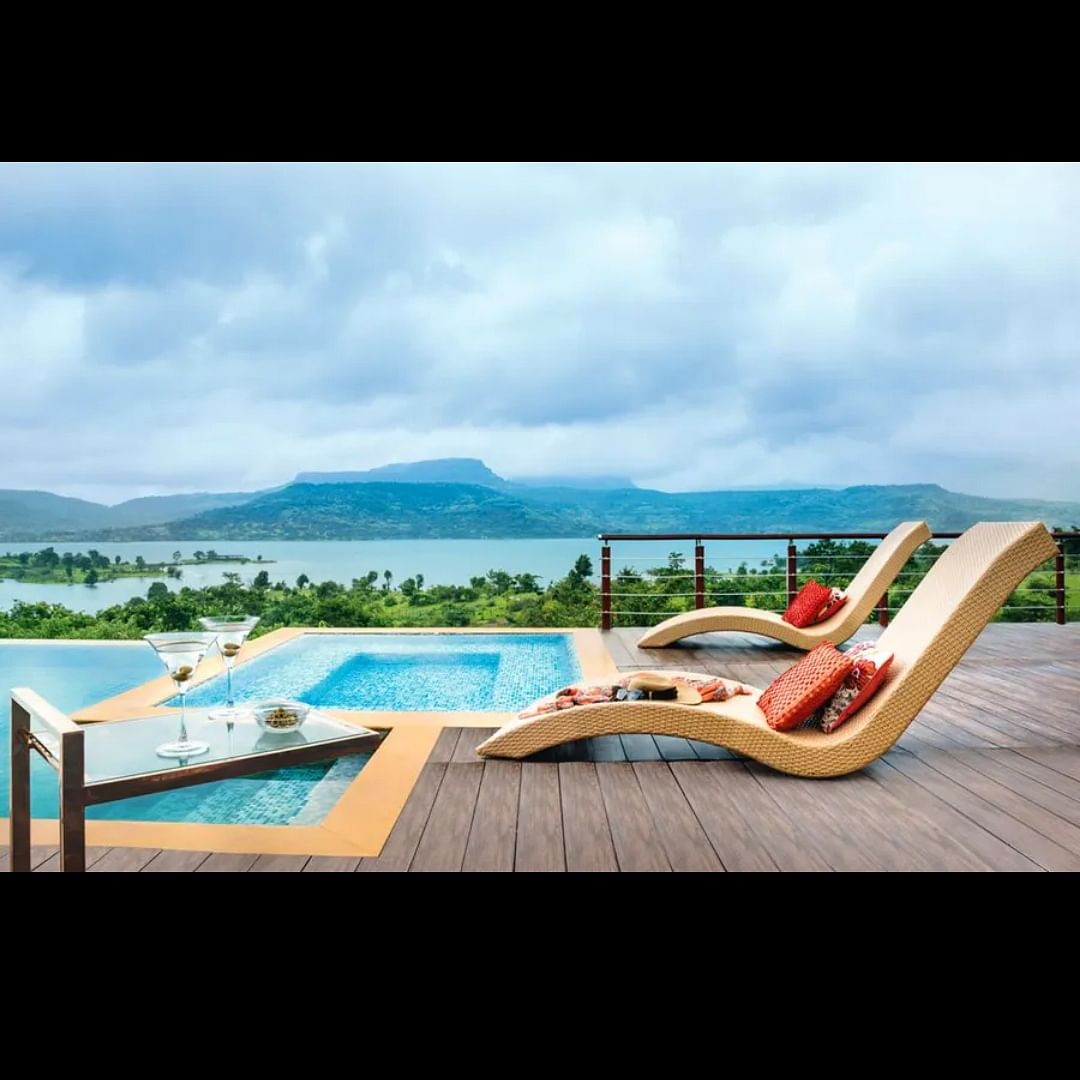 Cloud,Sky,Water,Plant,Furniture,Seaside resort,Sunlounger,Outdoor furniture,Building,House