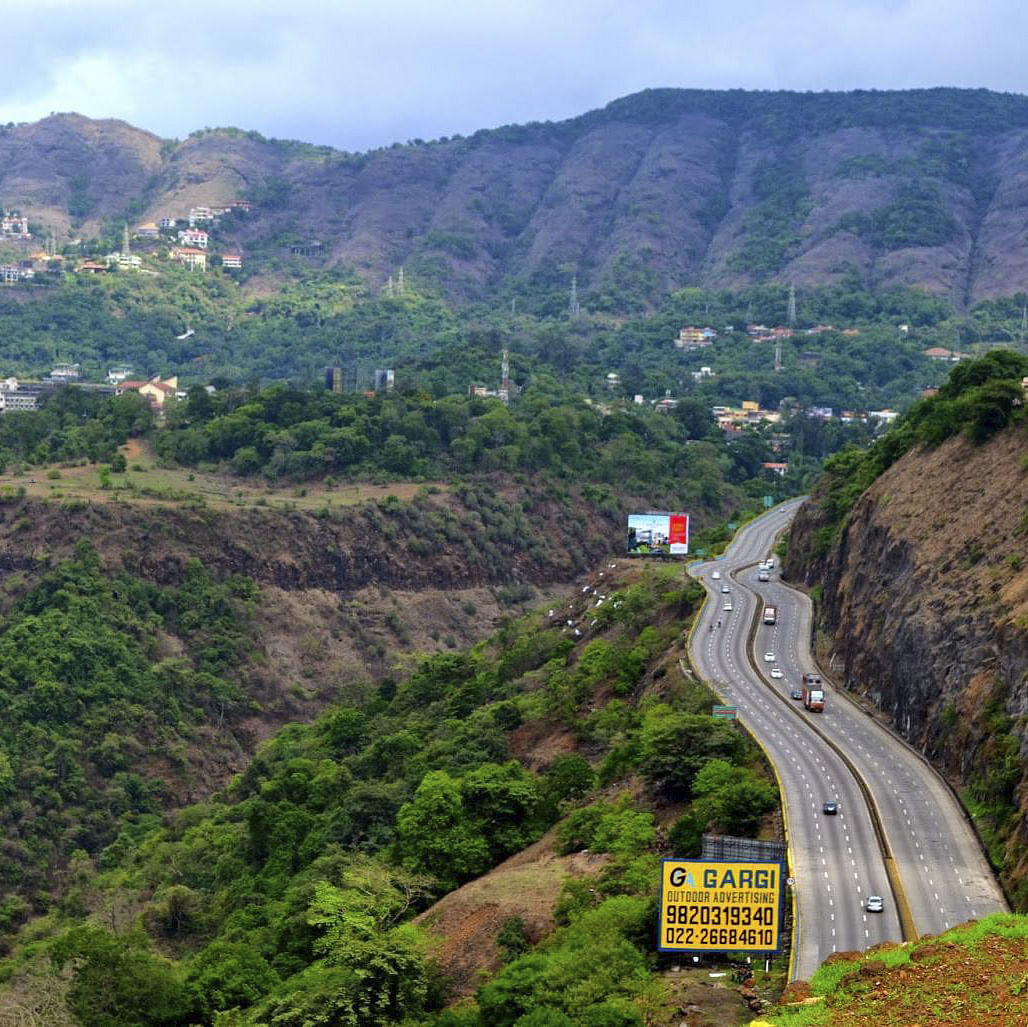 Mountain,Sky,Cloud,Plant,Plant community,Ecoregion,Natural landscape,Vegetation,Land lot,Road surface