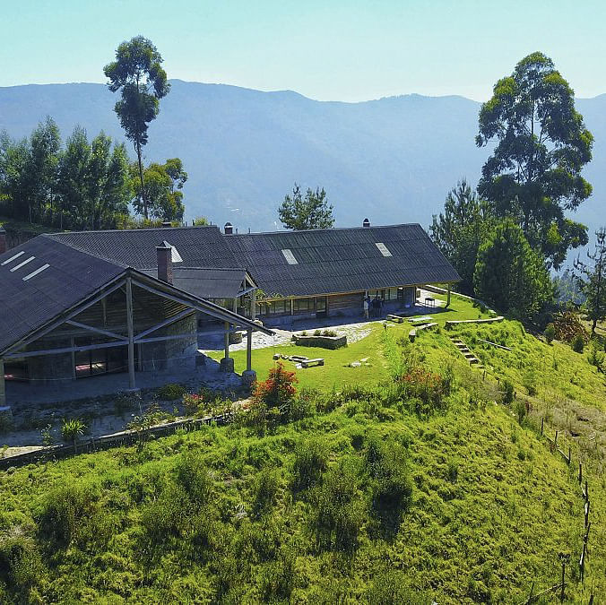 Sky,Plant,Plant community,Mountain,Tree,Building,Slope,Natural landscape,Window,Land lot