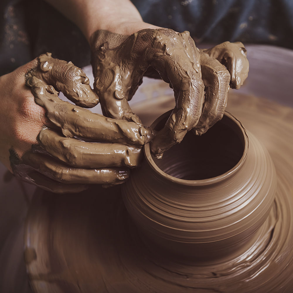 Potter's wheel,Wood,Clay,Automotive tire,Artifact,Art,Auto part,Machine,Metal,Wrist