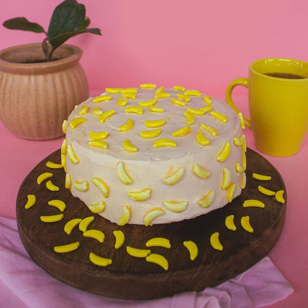 Food,Cake decorating,Cake,Cake decorating supply,Hat,Flowerpot,Plant,Yellow,Dishware,Cuisine