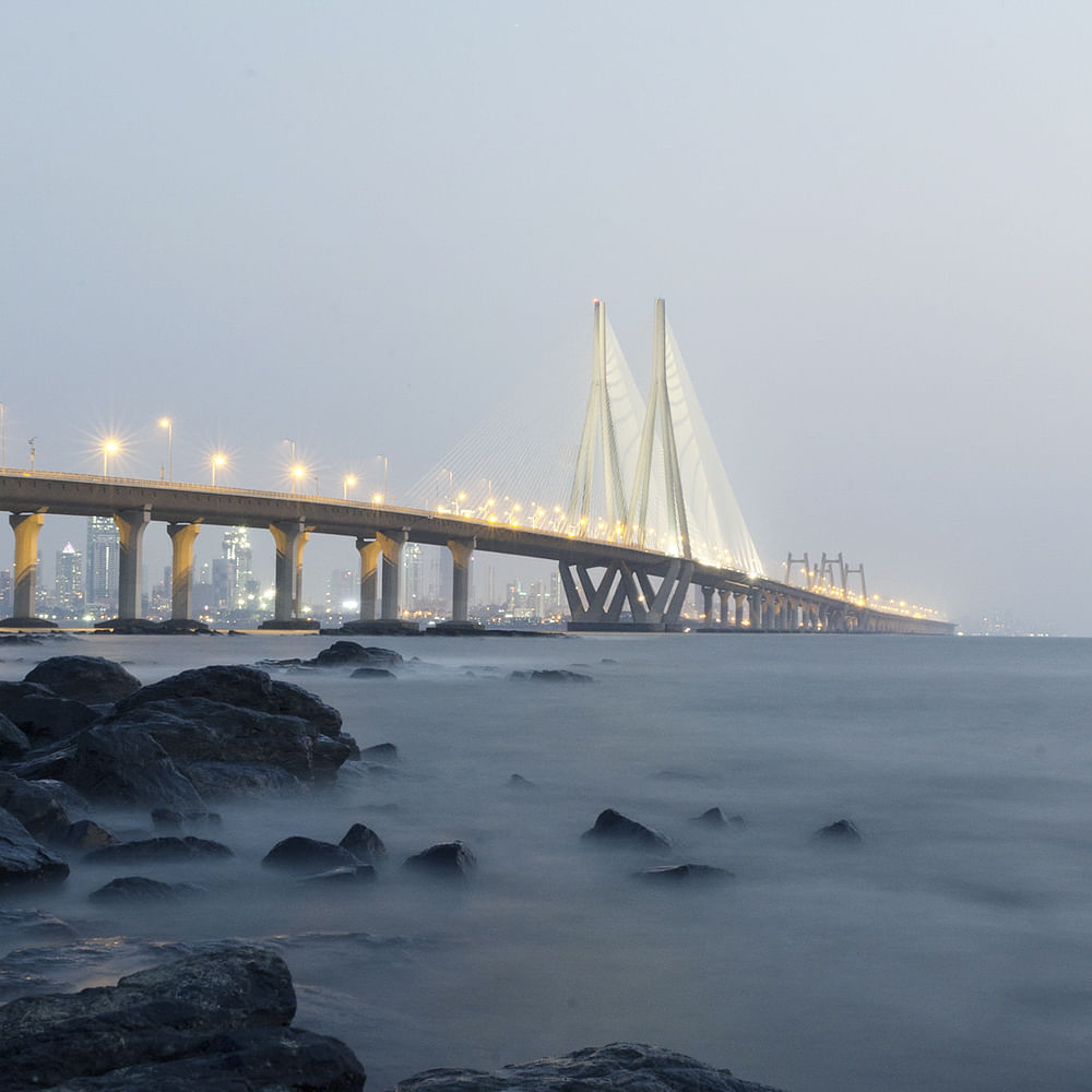 Water,Sky,Atmospheric phenomenon,Cloud,Horizon,Dusk,Bridge,City,Girder bridge,Freezing