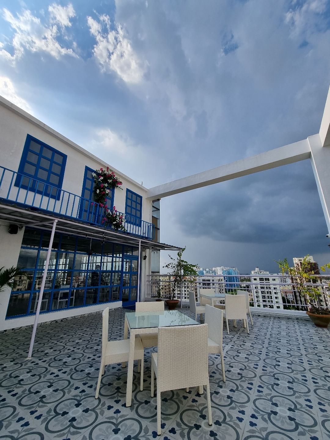 Cloud,Sky,Daytime,Property,Building,Table,Chair,Azure,Outdoor furniture,Urban design