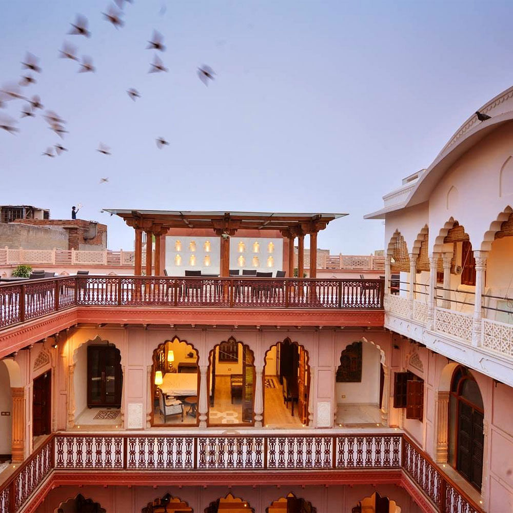 Sky,Building,Property,Bird,Window,Wall,Leisure,Public space,Morning,Roof