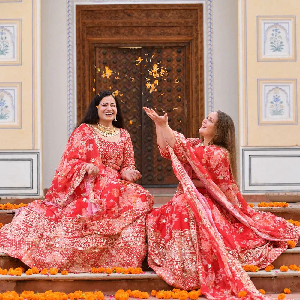 Hairstyle,Smile,Picture frame,Sleeve,Temple,Dress,Entertainment,Gown,Fashion design,Red