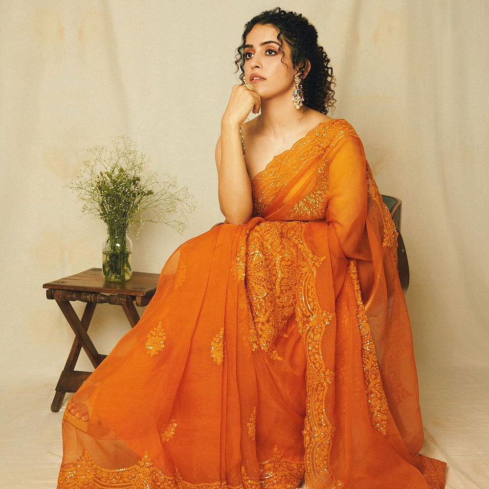 Hair,Arm,Plant,Human body,Neck,Sari,Orange,Sleeve,Waist,Gown