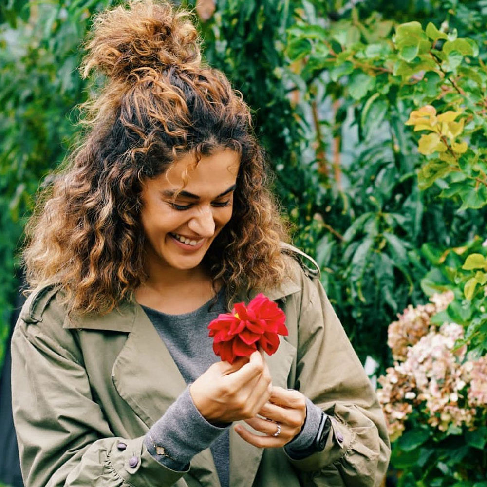 Flower,Hand,Smile,Plant,People in nature,Botany,Happy,Petal,Grass,Fawn