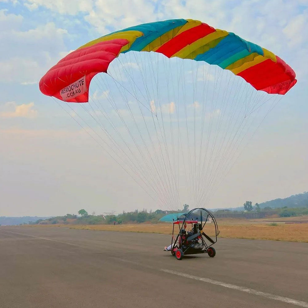 Sky,Cloud,Ecoregion,Parachute,Paragliding,Travel,Parachuting,Grass,Landscape,Grassland