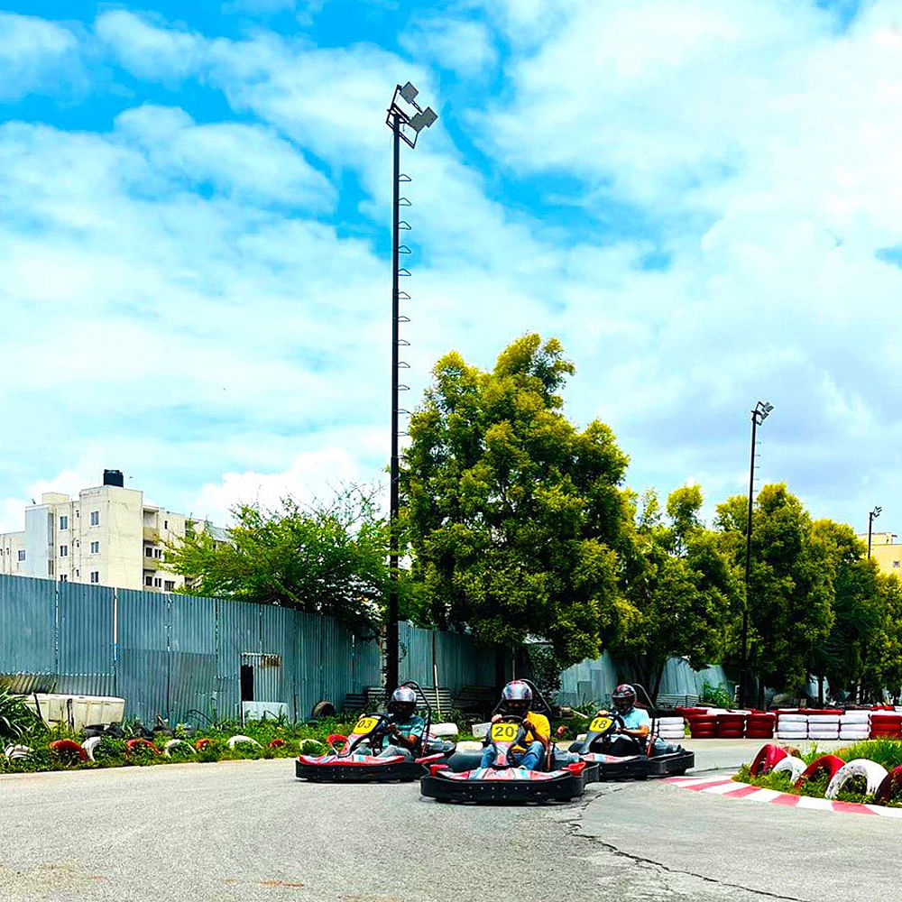 Cloud,Sky,Plant,Street light,Blue,Tree,Road surface,Asphalt,Building,Urban design