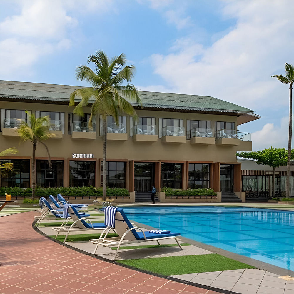 Sky,Cloud,Plant,Water,Tree,Swimming pool,Outdoor furniture,Building,Shade,Arecales