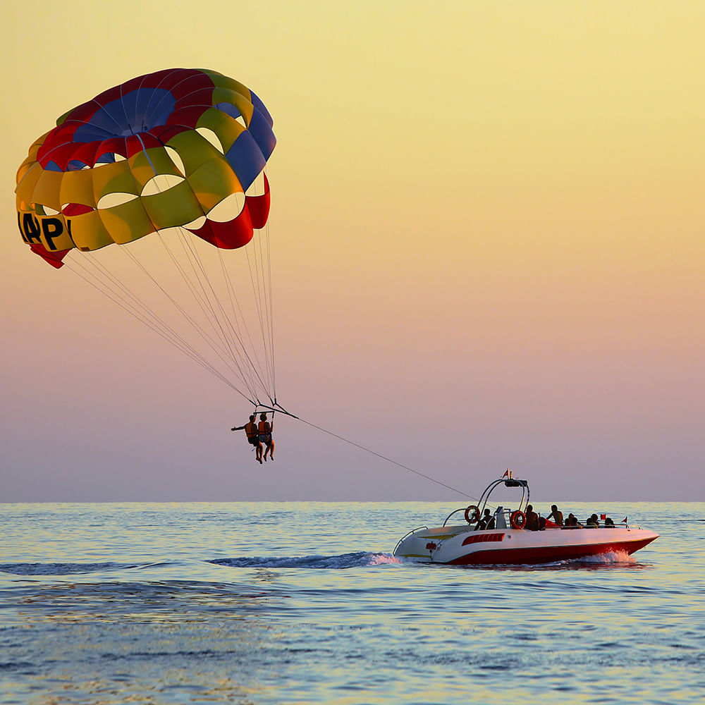 Water,Sky,Boat,Nature,Natural environment,Vehicle,Parachute,Watercraft,Travel,Lake