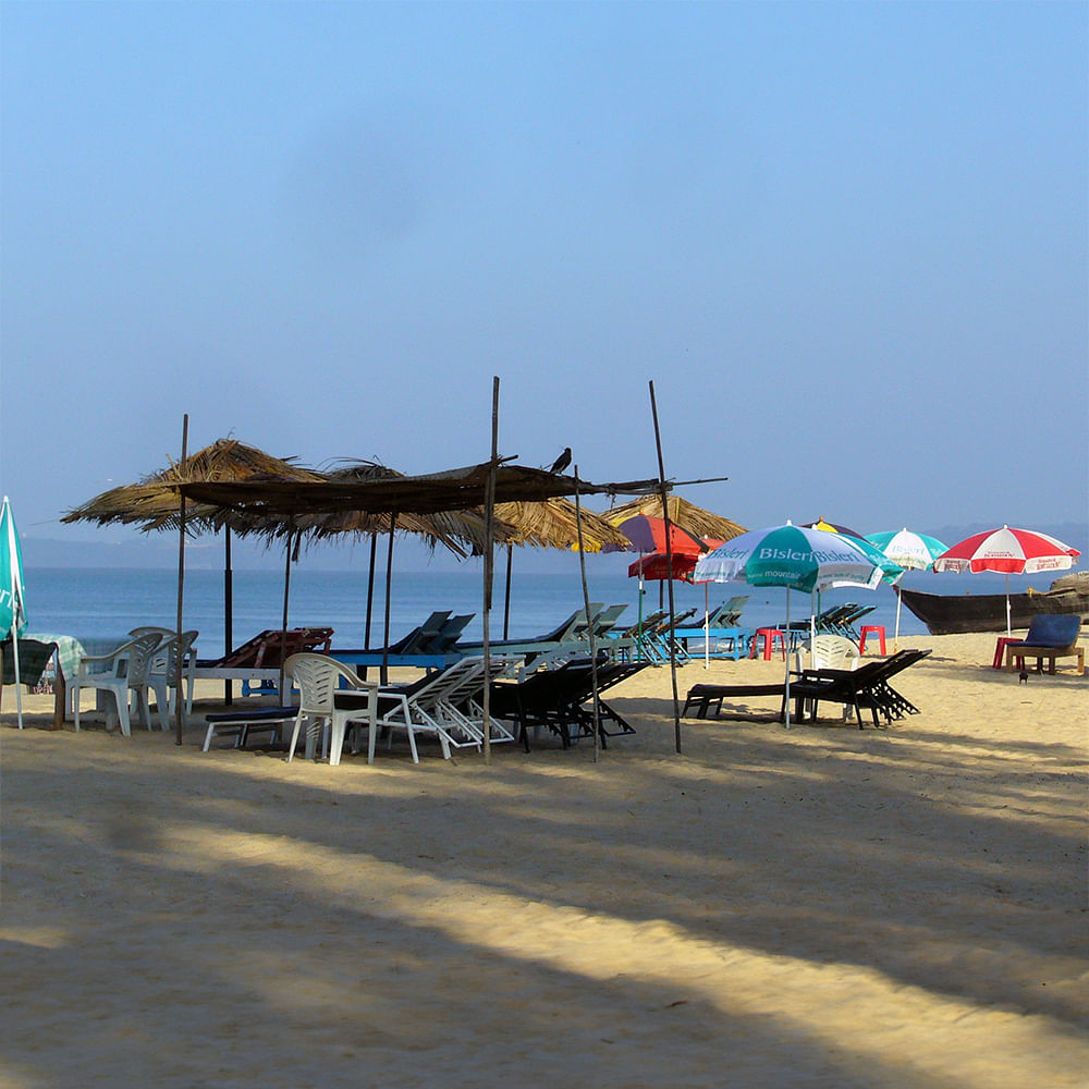 Sky,Water,Shade,Beach,Travel,Coastal and oceanic landforms,Outdoor furniture,Sunlounger,Horizon,Leisure