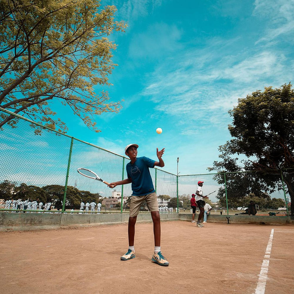 Playing sports,Sky,Cloud,Tree,Sports equipment,Shorts,People in nature,Leisure,Ball,Summer