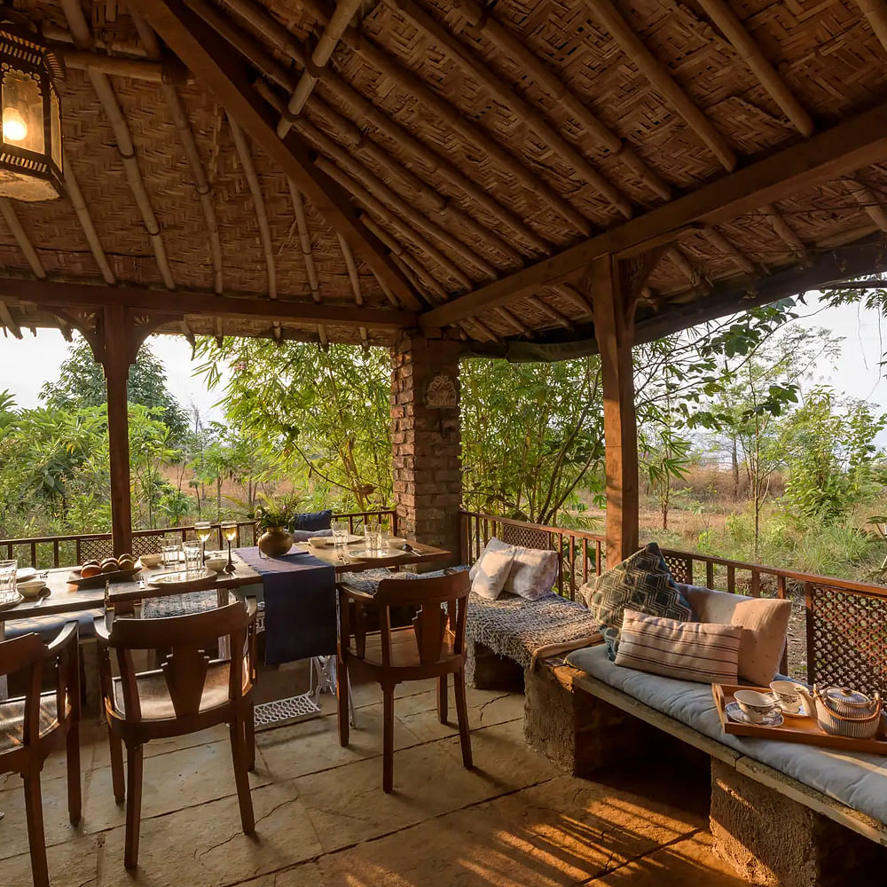 Furniture,Table,Shade,Interior design,Wood,Chair,Plant,Tree,Leisure,Cottage