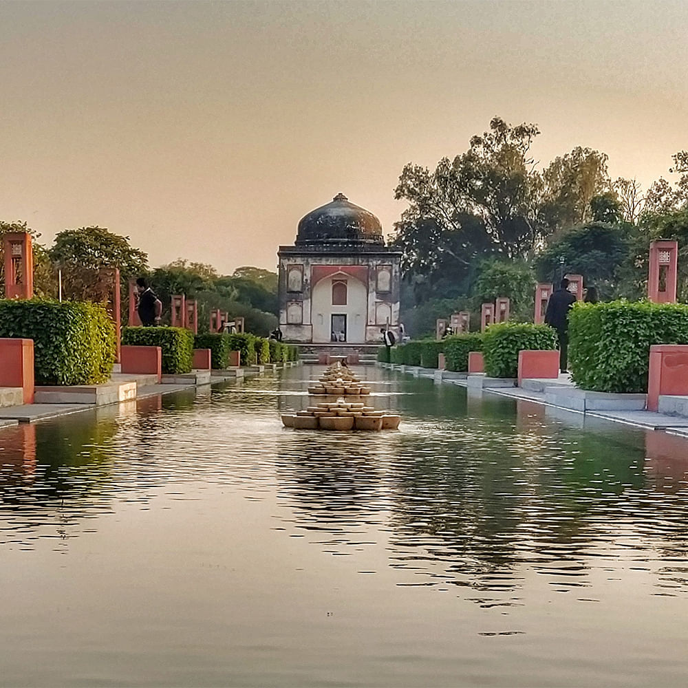 Water,Sky,Plant,Tree,Building,Watercourse,Boat,Natural landscape,Bank,Leisure