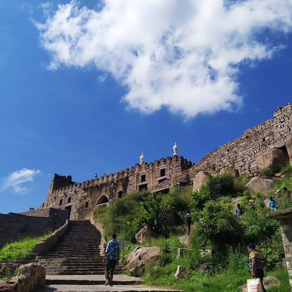 Cloud,Sky,Plant,Building,Grass,Landscape,Archaeological site,Stone wall,Stairs,Tree