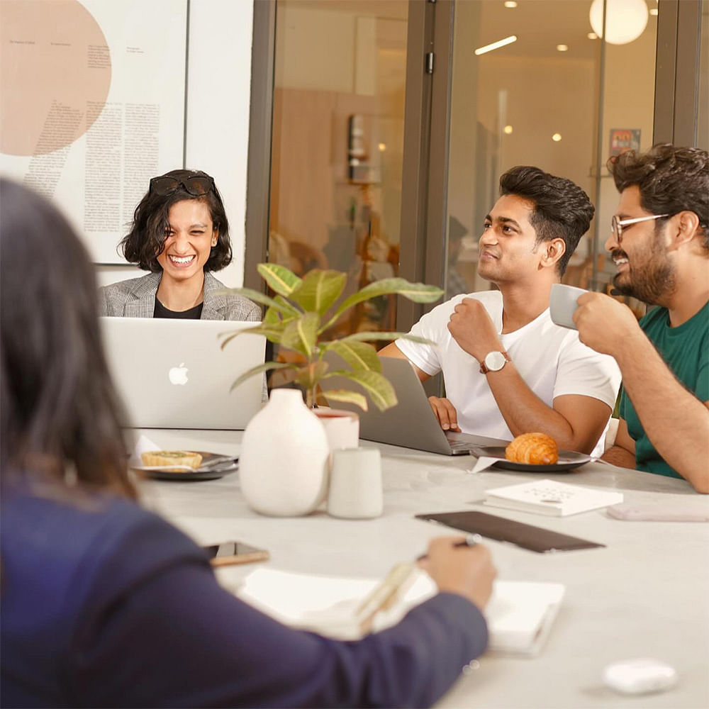 Plant,Smile,Laptop,Table,Human,Fashion,Tableware,Interior design,Personal computer,Interaction