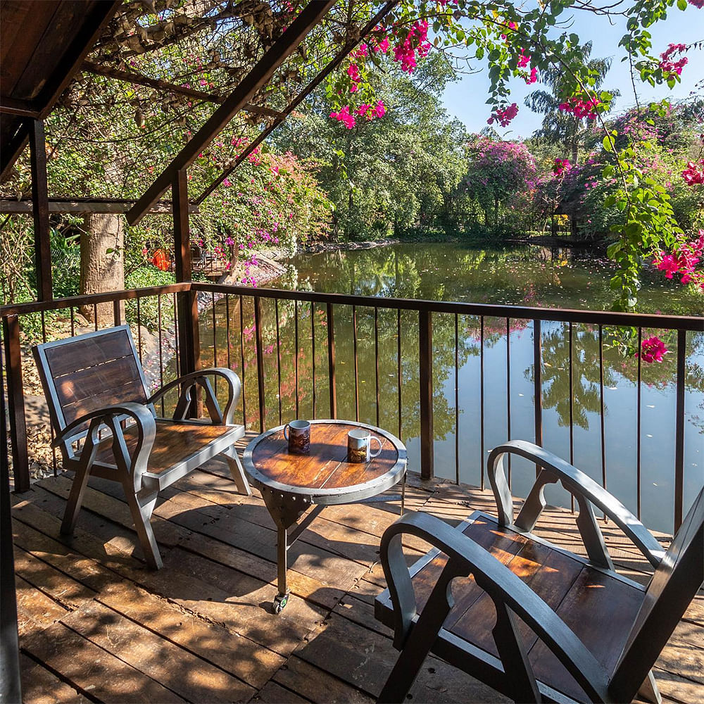 Porch,Deck,Shade,Resort,Eco hotel,Chair,Hardwood,Outdoor furniture,Balcony,Reflection