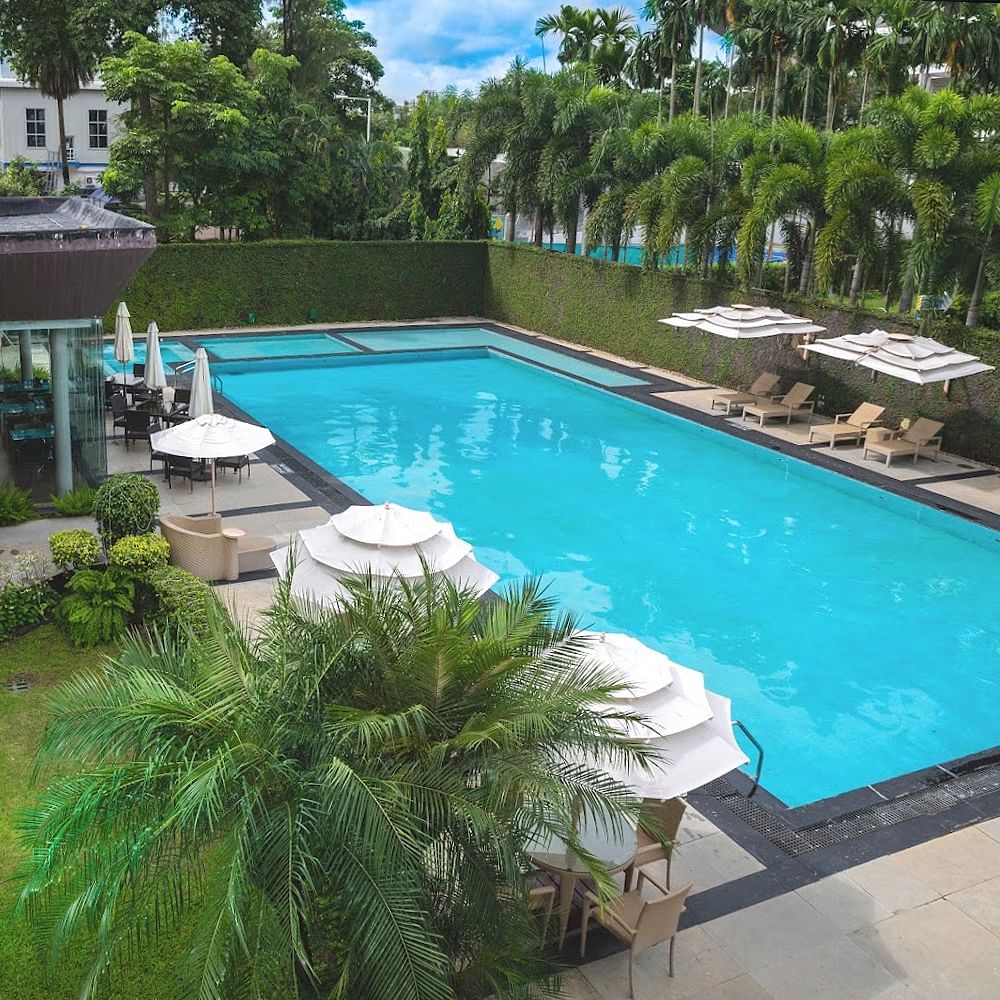 Swimming pool,Water,Outdoor furniture,Resort,Umbrella,Leisure,Sunlounger,Eco hotel,Shade,Hotel