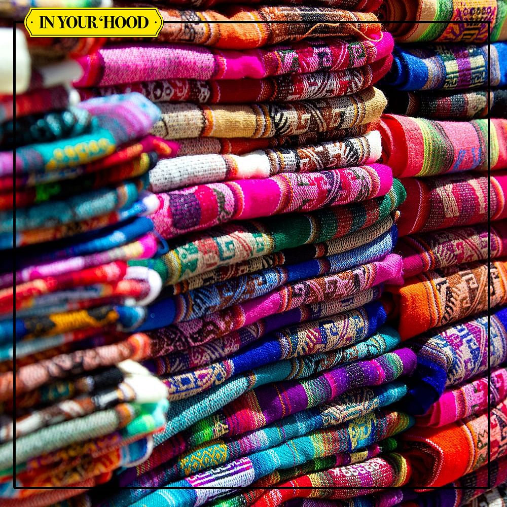 Red,Textile,Pink,Purple,Creative arts,Market,Woven fabric,Retail,Weaving,Linens