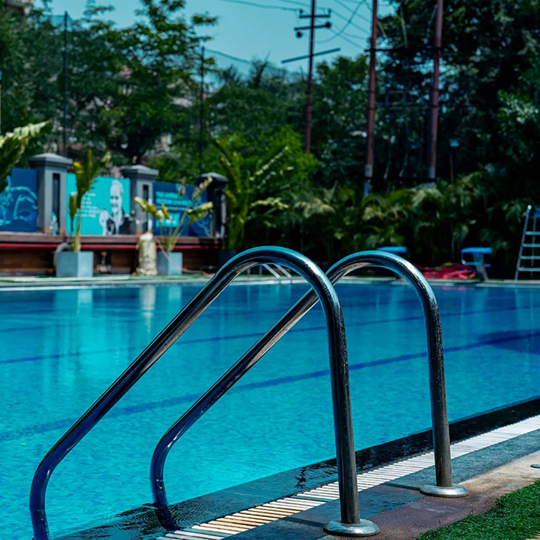 Blue,Swimming pool,Leisure,Resort,Recreation,Composite material,Leisure centre,Shade,Palm trees,Vacation