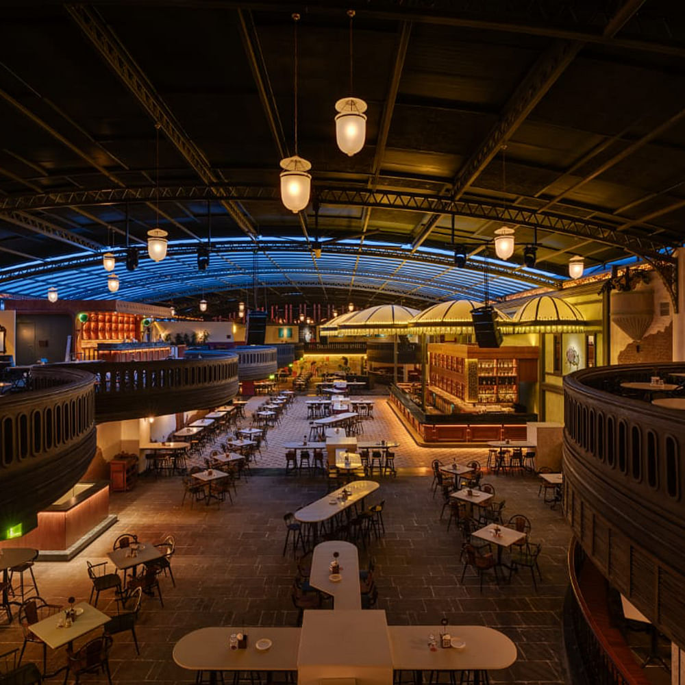 Lighting,Ceiling,Interior design,Restaurant,Night,Light fixture,Chair,Hall,Varnish,Food court