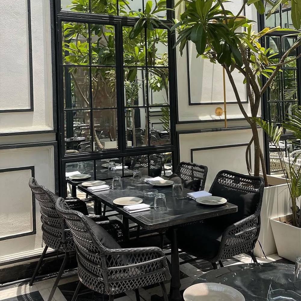 Furniture,Chair,Restaurant,Glass,Kitchen & Dining Room Table,Houseplant,Design,Coffee table,Outdoor Table,Cafeteria