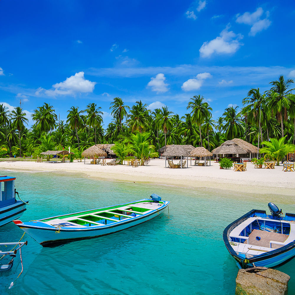 Blue,Body of water,Beach,Coastal and oceanic landforms,Boat,Sea,Coast,Resort,Caribbean,Tourist attraction