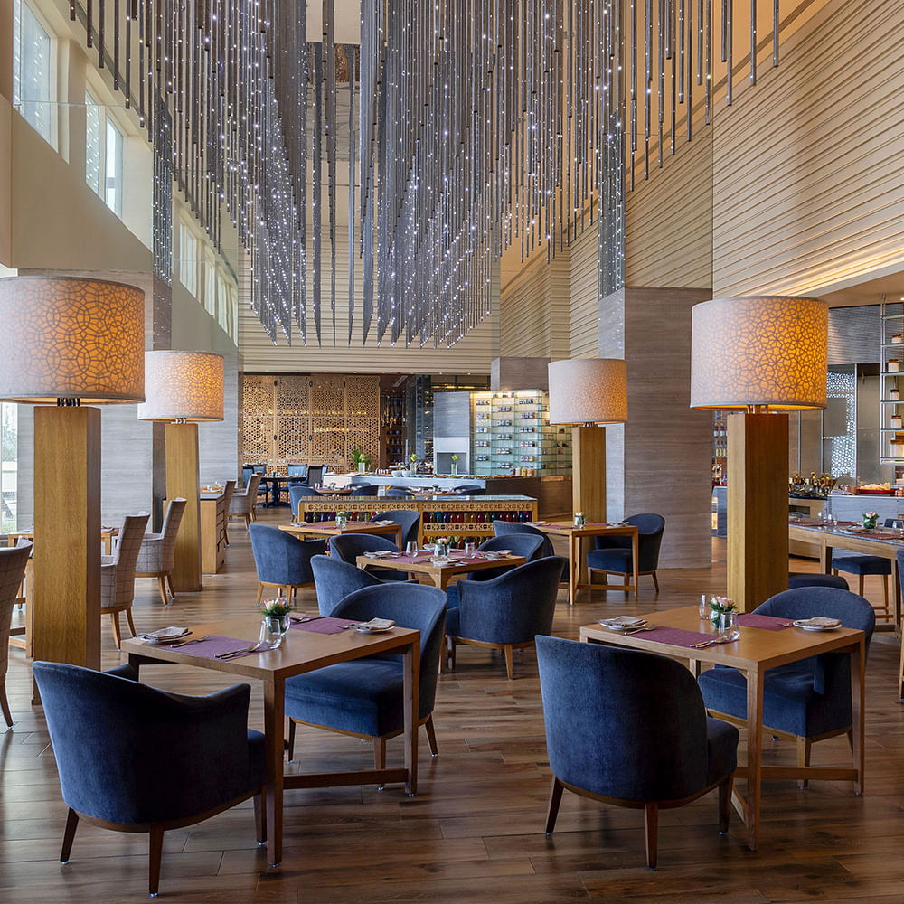 Interior design,Furniture,Ceiling,Light fixture,Chair,Flooring,Lighting,Chandelier,Table,Restaurant