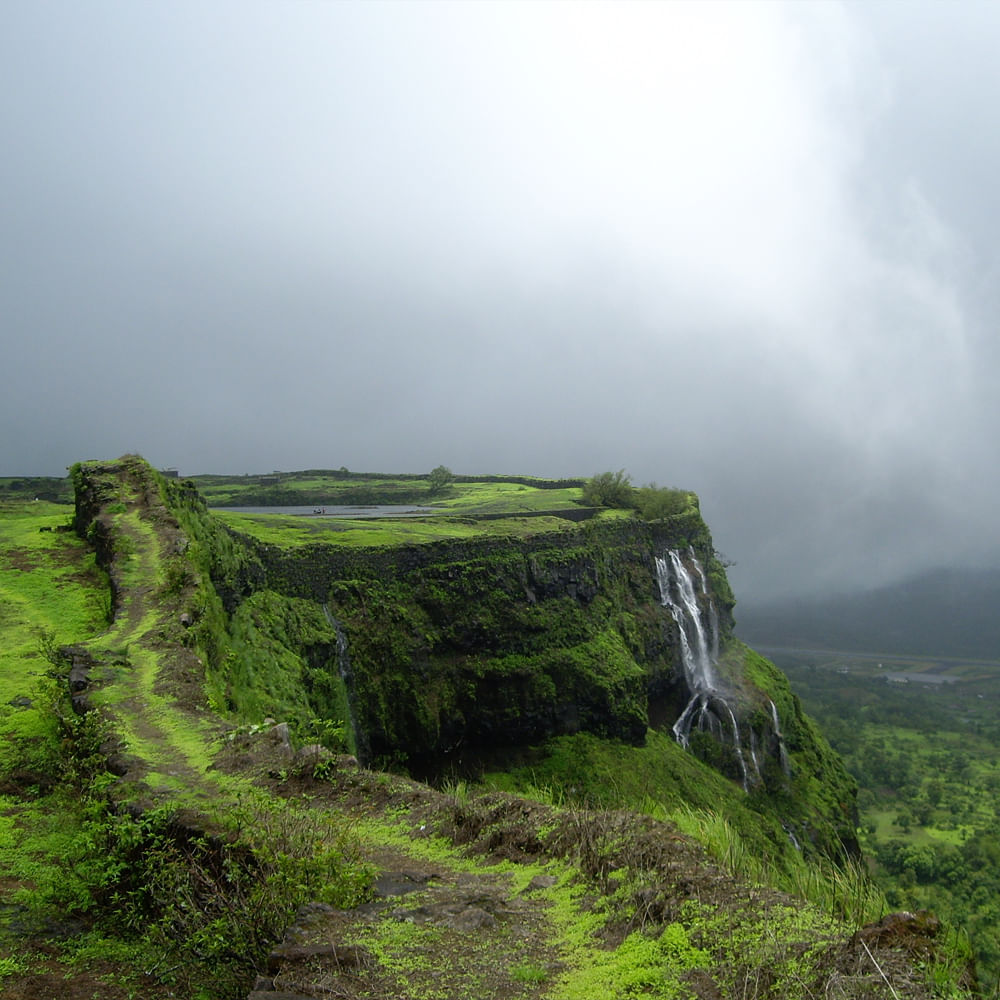 Natural landscape,Highland,Hill,Terrain,Hill station,Groundcover,Tourist attraction,Nature reserve,Mist,Waterfall