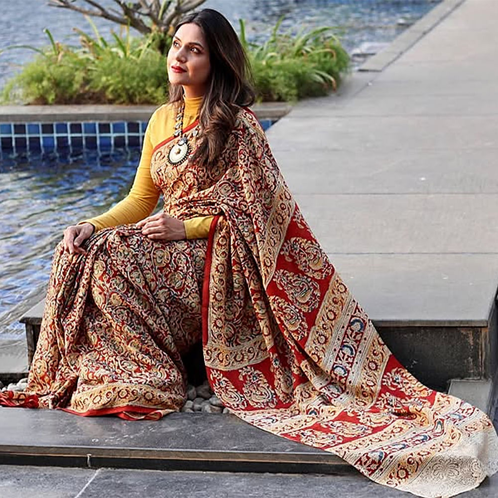 Sari,Temple,Textile,Motif,Tradition,Fashion design,Silk,Long hair,Shawl,Wrap