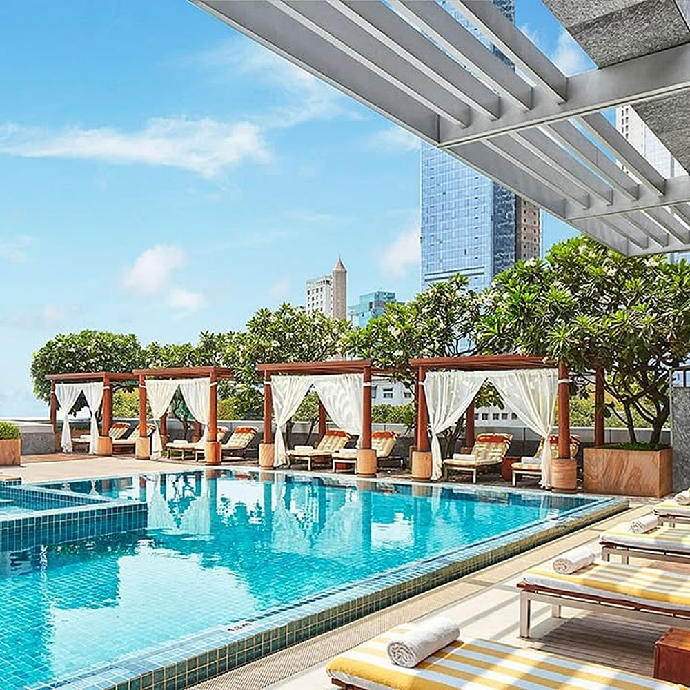 Swimming pool,Outdoor furniture,Resort,Furniture,Leisure,Condominium,Apartment,Sunlounger,Chair,High-rise building