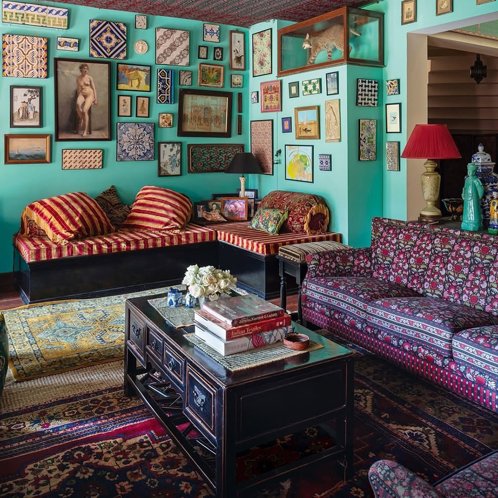 Furniture,Interior design,Couch,Wall,Living room,Carpet,Textile,Picture frame,Flooring,Room